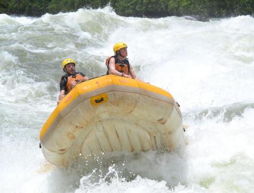 Travelers on a whitewater rafting activity in Uganda Jinja on Lake Victoria